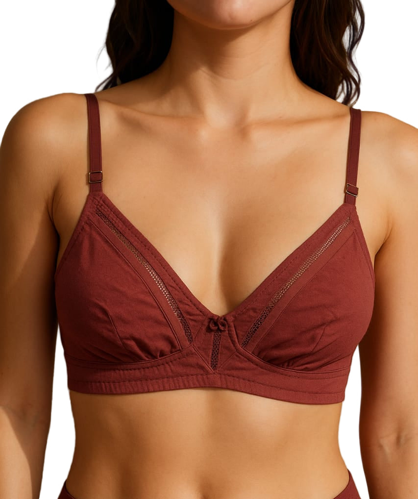 Person wearing a maroon bra and underwear set against a neutral background