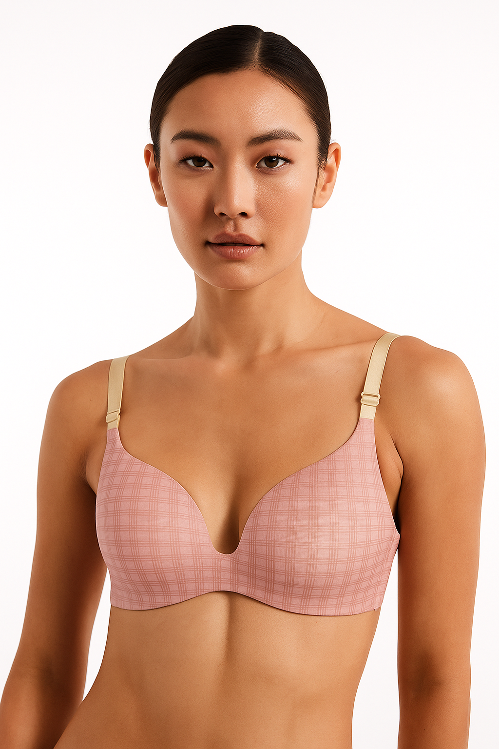 Woman wearing a pink checkered bra against a white background