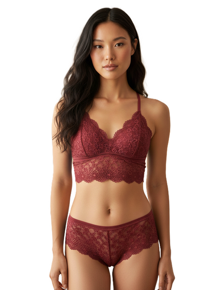 Woman wearing a red lace lingerie set on a white background