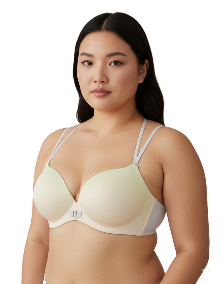 Woman wearing a light-colored bra against a white background