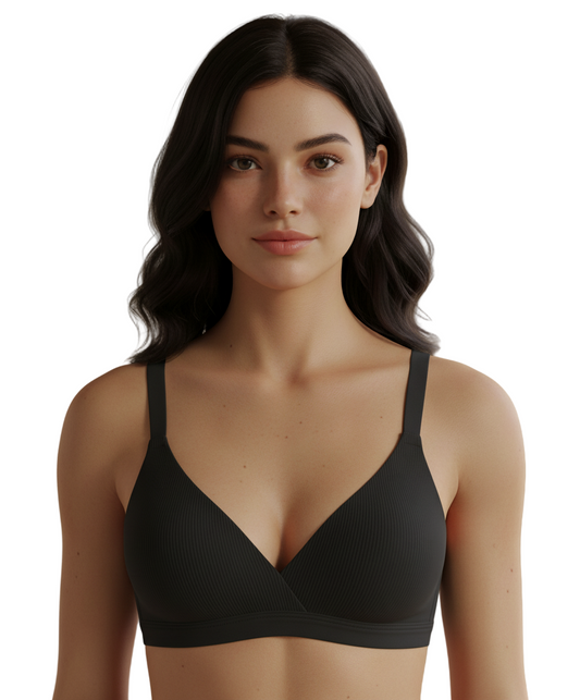 Woman wearing a black T shirt bra against a neutral background