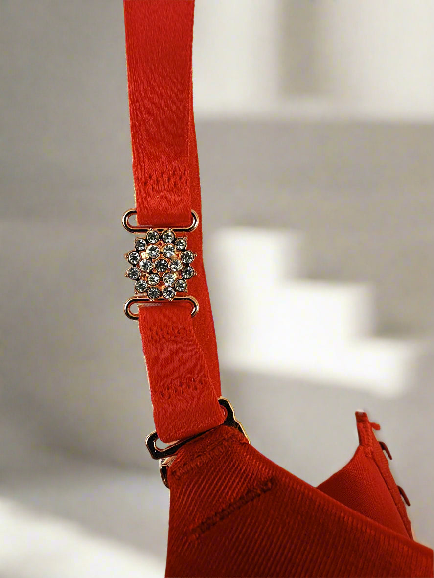 Red bra with a decorative clasp on a white background