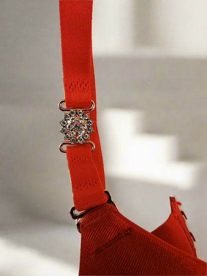 Red bra with a decorative clasp on a white background